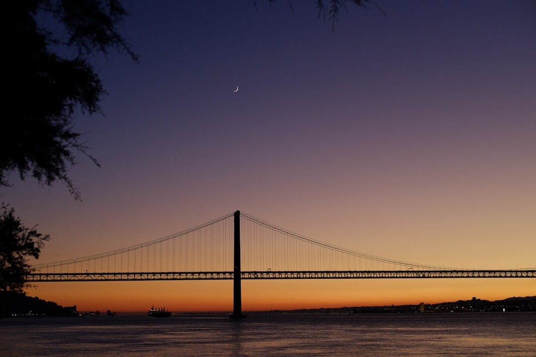 Lisbon city skyline at dusk with the Tagus river