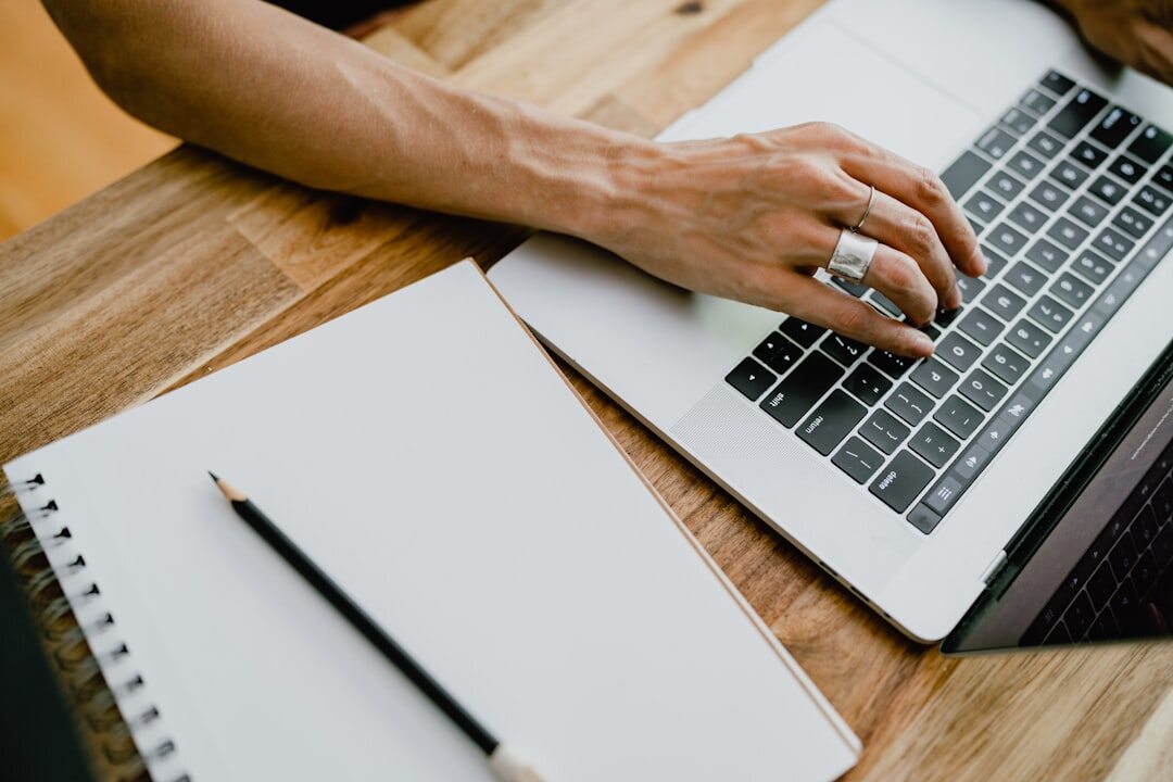 person writing blog post on laptop