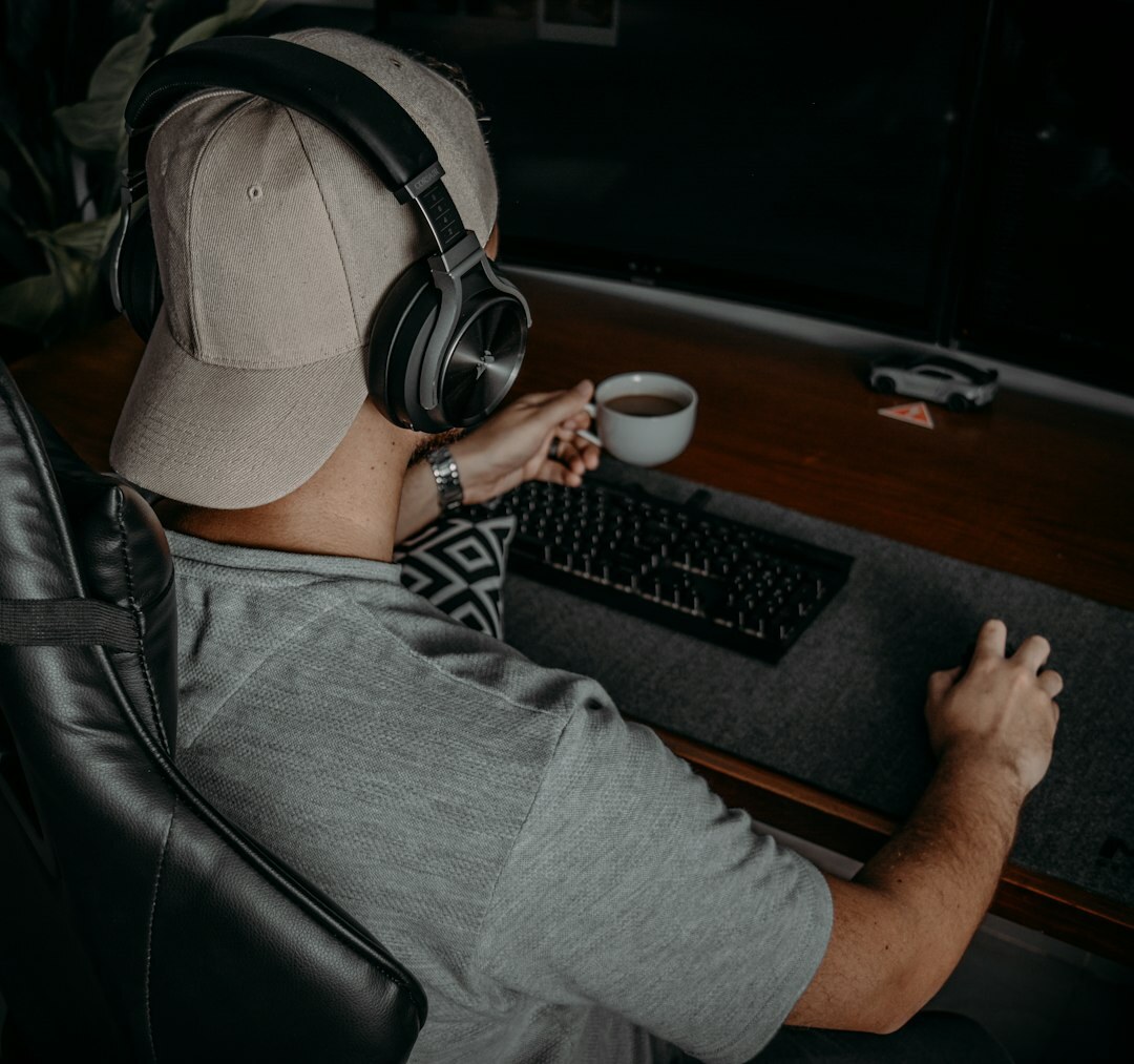 Woman wearing headphones editing audio at a laptop