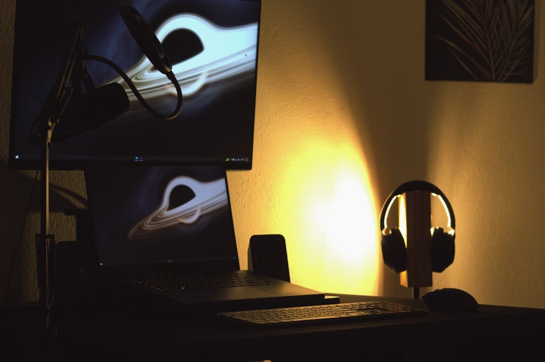 Podcast editing workspace with a laptop and headphones on a desk