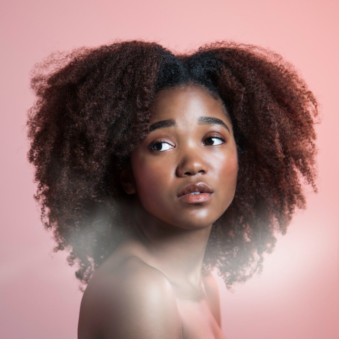 Studio portrait of a young woman with curly hair