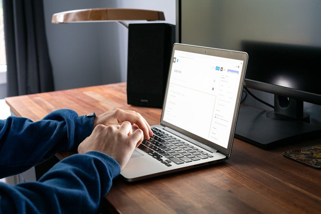 person writing blog post on laptop