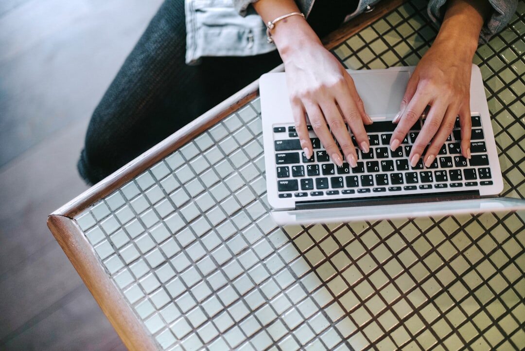 person writing blog post on laptop