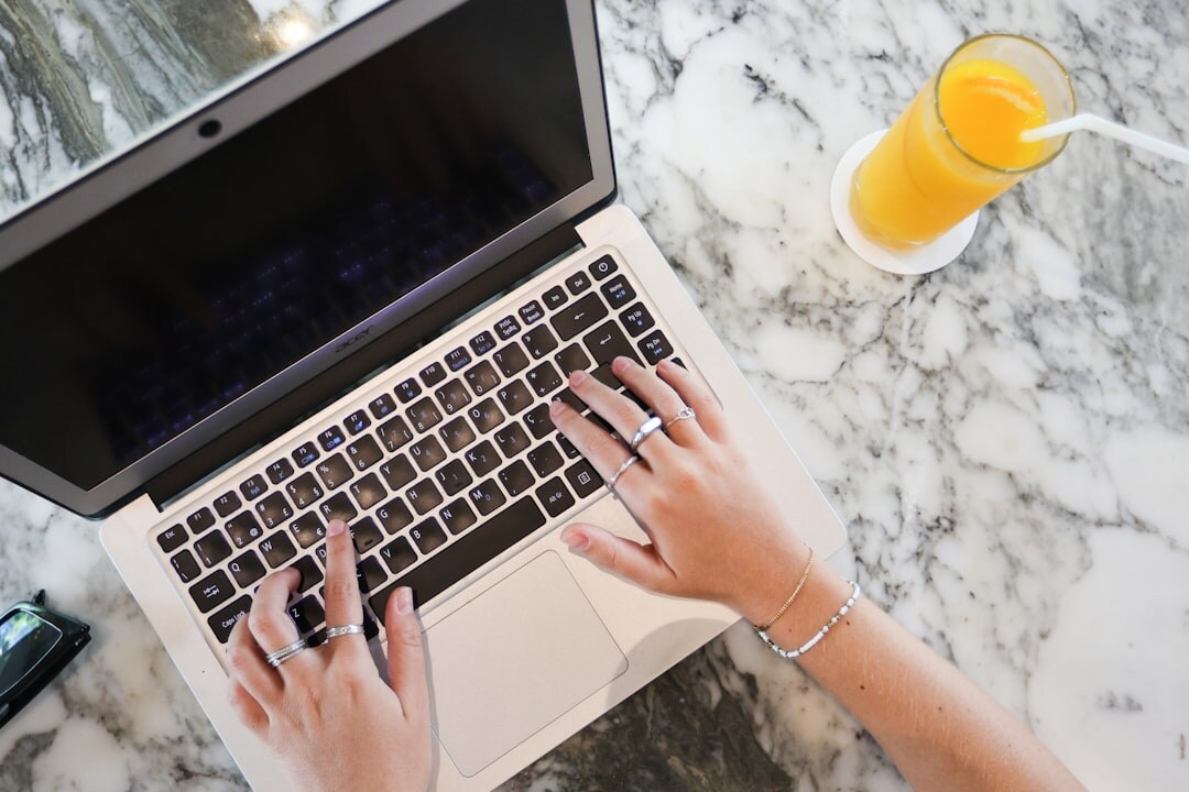 blogger typing on laptop