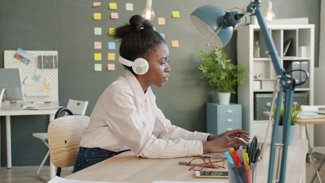 woman editing podcast on computer